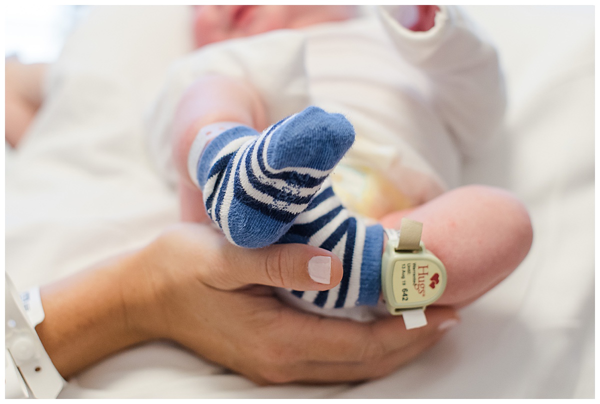 baby feet in striped socks during hospital newborn session at banner thunderbird hospital