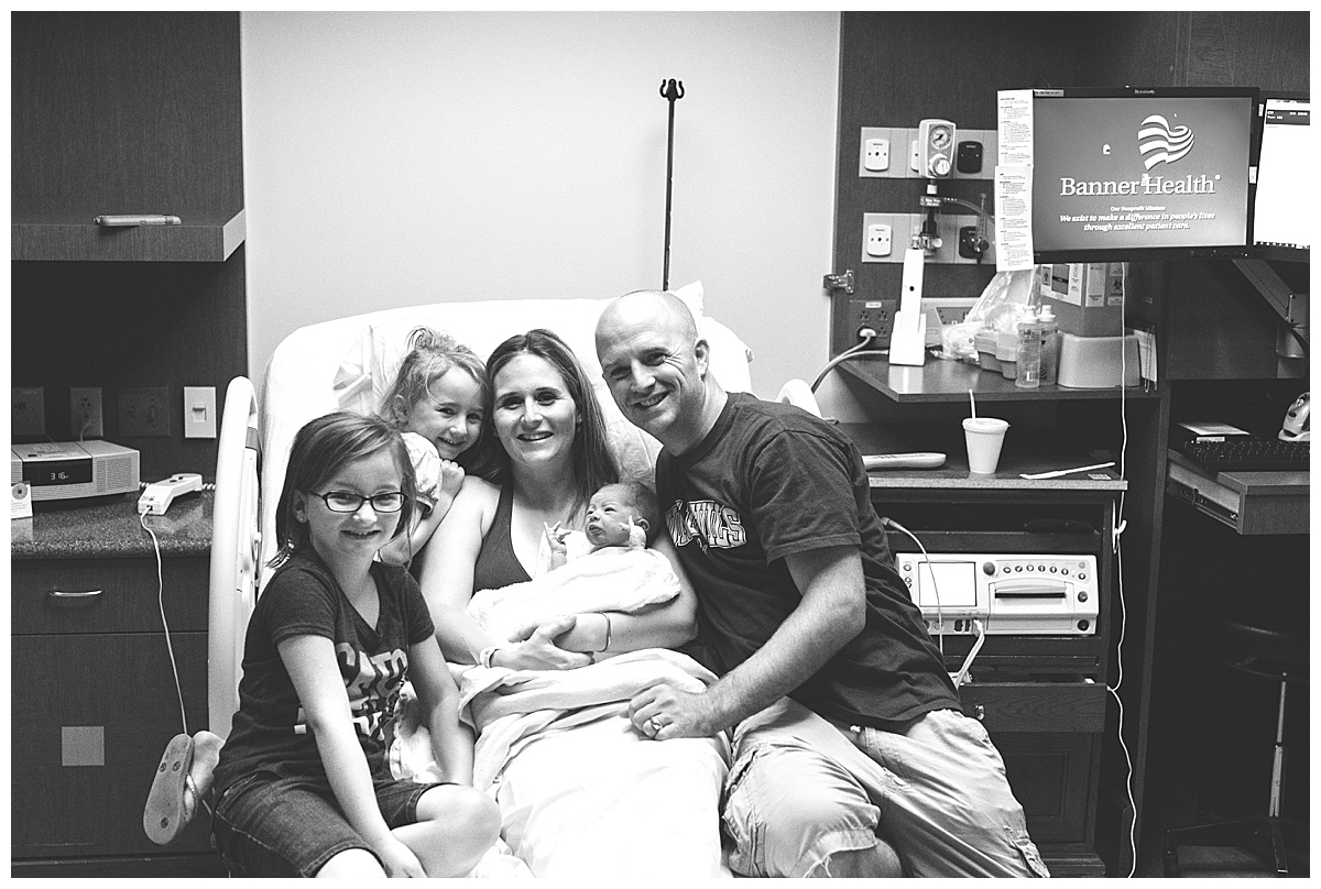 family portrait following birth of new baby in delivery room