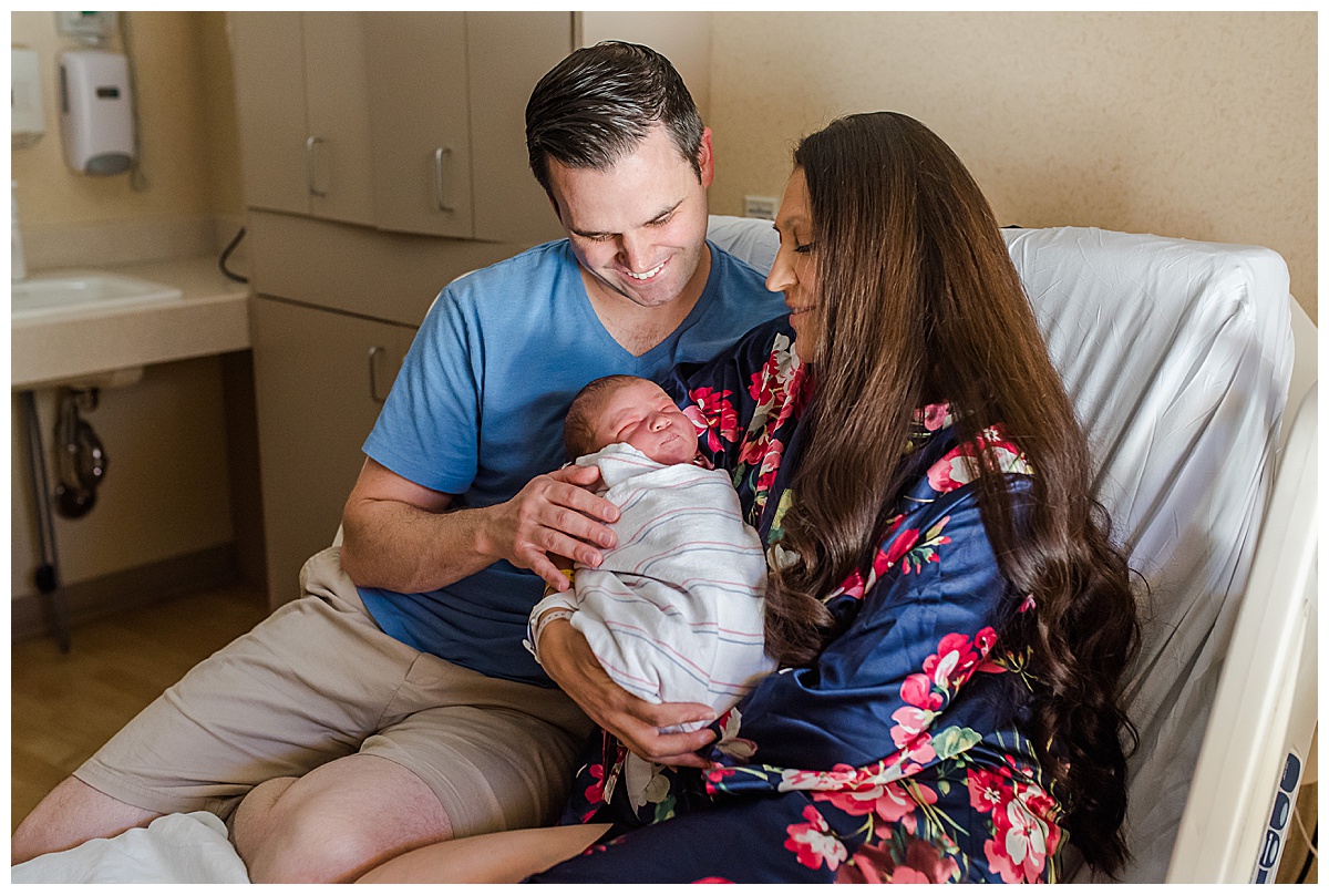 Mom and dad gaze adoringly at newborn baby boy in Scottsdale Shea hospital maternity ward