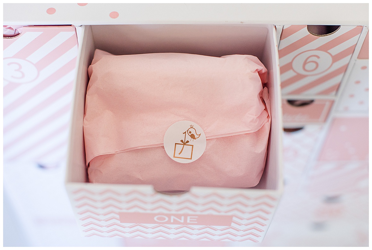 Close up of drawer number one with a small gift wrapped in pink tissue paper inside the drawer