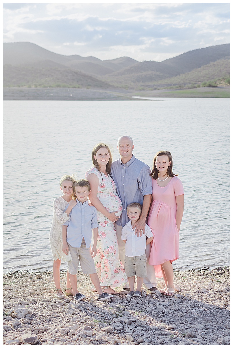 Mom, dad and four children pose on the shore of Lake Pleasant during family maternity session