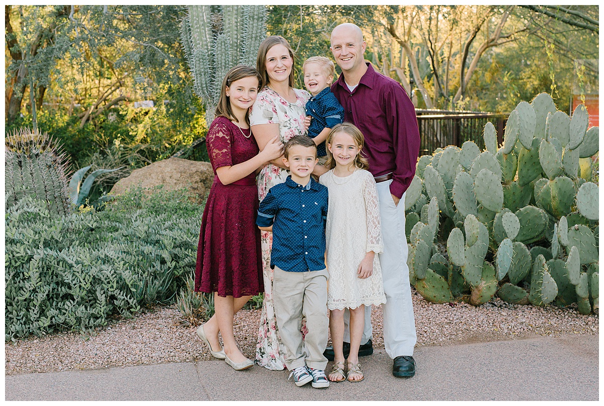 color photo of a family of six posing in front of cacti at the Desert Botanical Gardens, Phoenix, Arizona